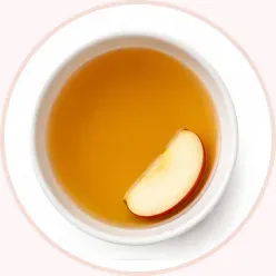 A small bowl of Apple Cider Vinegar with a fresh apple slice